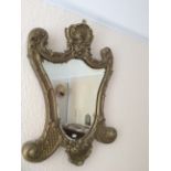 Swept gilt framed wall mirror with bevelled edge
