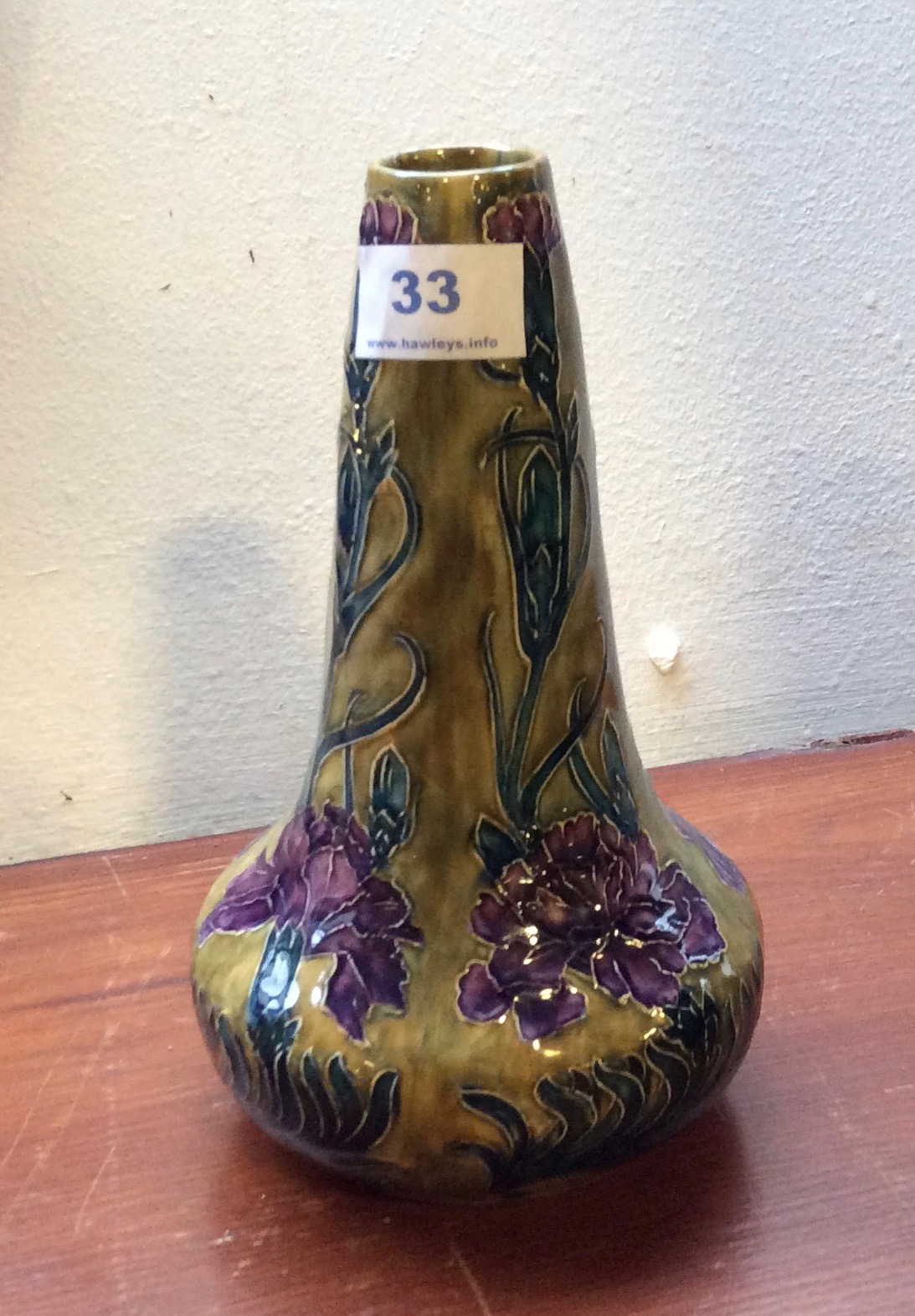 Morris Ware vase with tube lined decoration of stylised carnations on sinuous stems in purple,