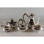 A five piece silver tea and coffee set, maker EV Sheffield 1933, with oval engraved handed bodies