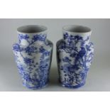 A pair of Oriental blue and white porcelain vases, cylindrical shouldered form, decorated with birds