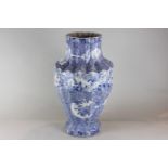 An oriental blue and white porcelain vase, fluted form, decorated with fans on a floral ground,