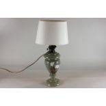 A green opaque glass oil lamp, baluster shape, decorated with flowers, now converted, height 35cm
