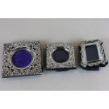 Two small embossed silver photograph frames and a small rectangular frame