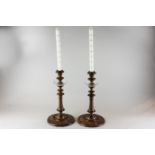 A pair of late 19th/early 20th century carved wood candlesticks with glass 'drips' and turned