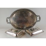 An oval plated two-handled tea tray and two rectangular plated entree dishes