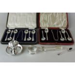 A cased set of six George V silver coffee spoons and tongs; another set of five apostle spoons and