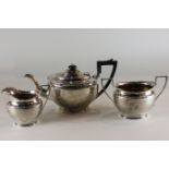 A three piece silver tea set, maker James Dixon and Sons Sheffield 1921, with oval bodies engraved