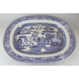 A large blue and white willow pattern serving dish, 58cm