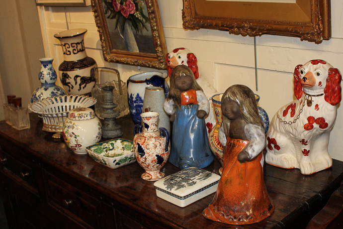 A mixed collection of glass and ceramics including a pair of Staffordshire spaniels, Quimper jug,