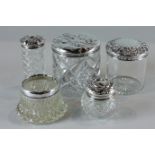 Four various silver lid glass dressing table jars and a silver mounted circular glass pot