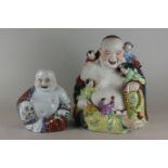 A Chinese porcelain Buddha seated smiling, with five playful children and decorated in bright