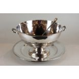 A silver plated two-handled circular soup bowl, 37cm; a serving spoon and a large circular plate,