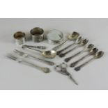 Two silver napkin rings, two small silver forks and two silver spoons, a silver mounted marmite