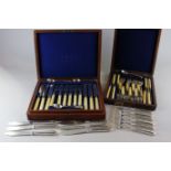 A cased set of twelve silver plated dessert knives and forks, a cased set of eight fish knives and