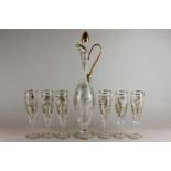 A continental ornate glass, jug and six drinking glasses with flute bowls, all decorated with