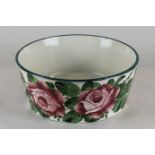 A Wemyss Ware circular bowl decorated with pink cabbage roses, impressed factory mark and T Goode