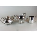 A plated circular cake basket with pierced border and swivel handle, together with a plated teapot