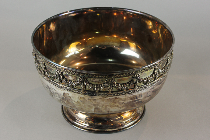 A silver plated circular rose bowl, the rim cast with floral swags, 26cm