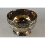 A silver plated circular rose bowl, the rim cast with floral swags, 26cm