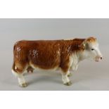 Beswick, a Hereford cow, glazed in brown and white, standing, 14cm high