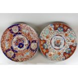 A late 19th century large Imari circular dish decorated in traditional colours with flowers,