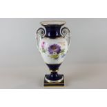 A late Meissen porcelain urn shaped vase, hand painted with summer flowers, and two side handles, on