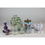 Four silver mounted cut glass scent bottles, a blue glass and gilt decorated scent bottle, two other