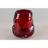 A red glass vase, possibly by Whitefriars, with dimpled surface, 13cm