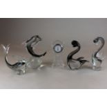 Two clear glass dolphin ornaments, two similar ducks and a glass miniature long case clock