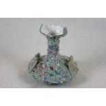 A Continental Art Nouveau style two handled porcelain vase with raised scroll and floral decoration,