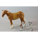 Beswick, a palomino horse designed by Shane Ridge, standing, 17cm high, together with a small foal