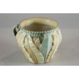 A Royal Worcester three-handled circular porcelain pot moulded with leaves, model number 1947,