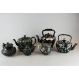 Six Victorian teapots including a barge ware teapot sprigged with flowers against a brown ground