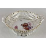 A Berlin KPM porcelain basket with floral centre and pierced sides, with two handles and gilt