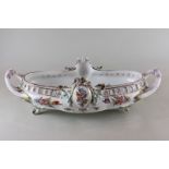 A Continental porcelain bowl, hand painted with flowers in bright colours and pierced with two
