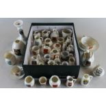 A collection of Goss and other crested china including jugs, pots, candlestick and two cups and