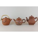 Two Chinese and one Japanese terracotta teapots decorated with character marks, naturalistic hand