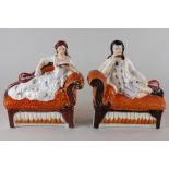 A pair of Staffordshire flatback figures of Robert Browning and Elizabeth Barrett Browning, lying on