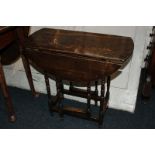 A small oak gate leg occasional table with oval top and two drop flaps, on turned legs, 63cm