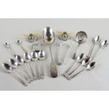 A collection of small items of silver to include two sets of six teaspoons, a pair of ivory and