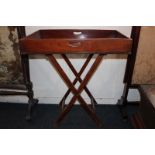 A 19th century mahogany butler's tray with gallery on folding stand