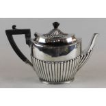 An Edwardian silver oval teapot, maker James Dixon and Sons Sheffield 1906, with half reeded body