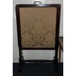 A 19th century mahogany extending fire screen with three pull-out material panels on splayed leg