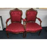 A pair of late 19th, early 20th century Louis XV style open arm elbow chairs with shaped backs and