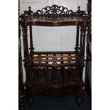 A Victorian figured walnut Canterbury whatnot with serpentine front and open shelf above music racks