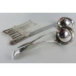 A plated Old English pattern soup ladle, another fiddle pattern soup ladle, a bread knife and six