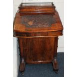 A Victorian walnut Davenport with writing slope and four side drawers and dummy drawers to reverse