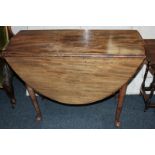 A small 18th century mahogany dining table with oval top and two drop flaps, on turned legs with pad