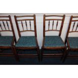 A set of four 18th century cottage oak dining chairs with triple spindle backs and wooden seats,