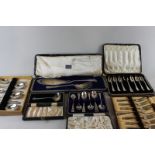 A set of six plated teaspoons; two sets of six pastry forks and servers in cases, plated fish